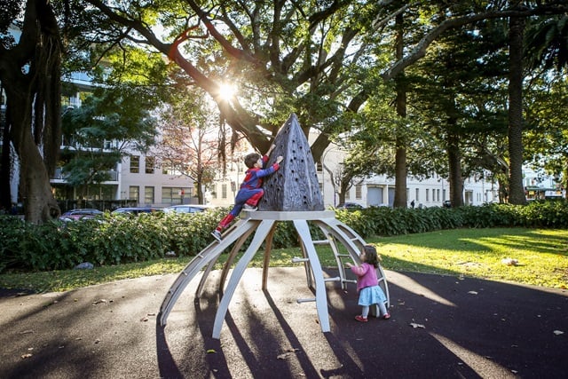 2 children climbing play equipment in Redfern Park Playground.