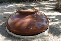 Bulbous water feature made from a single piece of sandstone