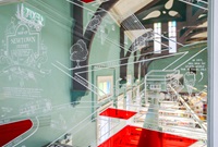 A line-art illustration using paint markers on glass panel.