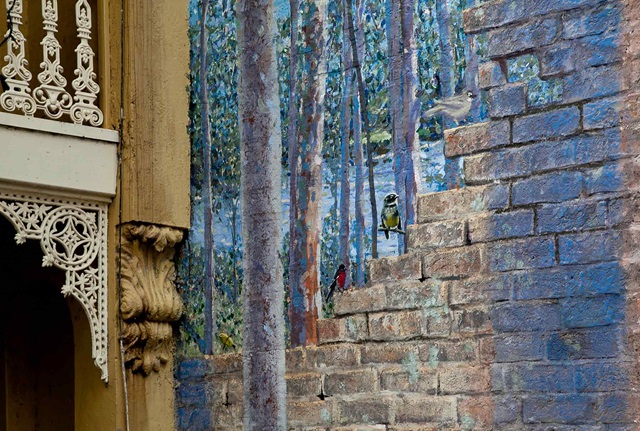 mural on a outdoor wall depicting a bush scene with Australian flora and fauna with  a bird as the focus at the centre