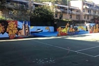 A tennis court with a mural painted in the background