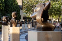 Several bronze bust sculptures on a sandstone plinths arranged in an arc