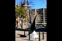 A very large bronze anchor mounted on a marble base.