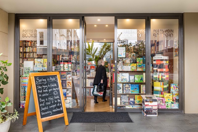 A customer enters the front doors of a bookshop.