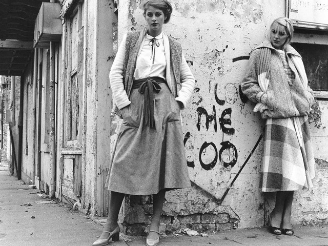 View showing two women posing next to graffiti We Love the Loo on wall of dilapidated building. City of Sydney Archives A-00066969.