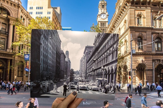In the foreground is an historic image of what is shown in the background. Images of people on a street and tall buildings either side.