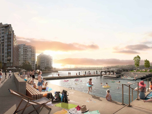 A computer rendered image showing apartment buildings and a harbour pool at sunset, with people swimming and relaxing by the pool.