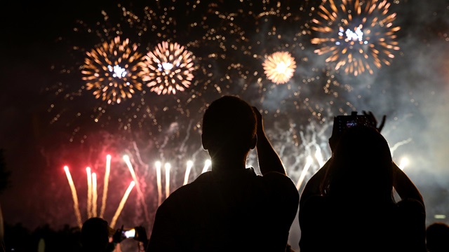 Silhouette of 2 people watching fireworks