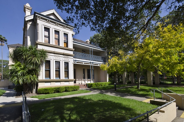 A view of Benledi community centre from the street featuring the facade and grassed front yard.