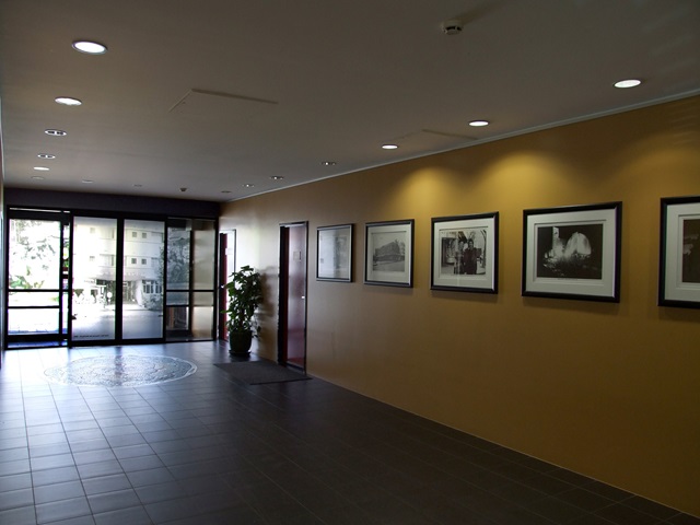 The centre's entrance has a large hallway and photos on the right wall.