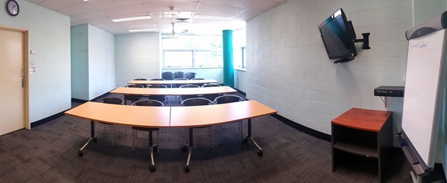 Large bright meeting room with seating at 3 tables