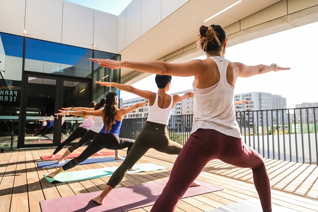 People doing yoga on the outdoor yoga deck.