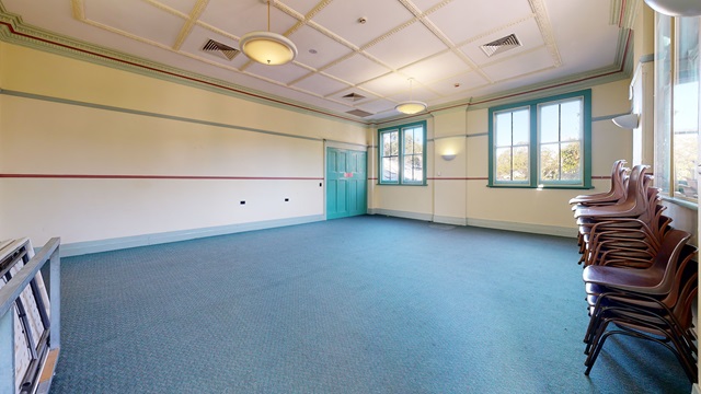 An empty room with chairs and windows.