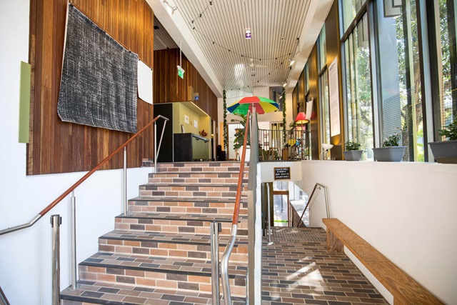 On the left are stairs leading to a mezzanine level, to the right is the hallway leading to stairs to the lower level.