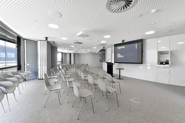 Chairs in rows in front of large display