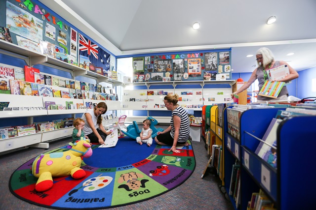 Children playing in the colorful children's area in Glebe Library.