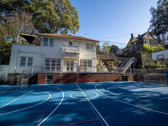 Large Community Centre building with basketball court in the foreground