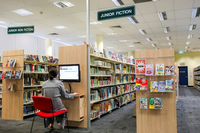 Lady using a self- service computer at Ultimo Library