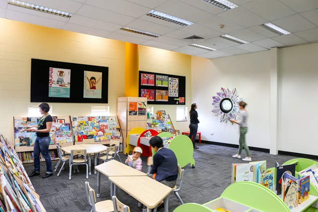 A library area with seating and people.