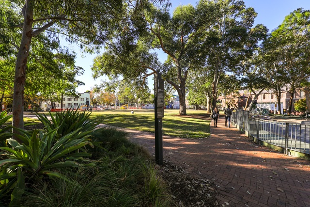 Couple strolling on the paved footpath at Eddie Ward Parl