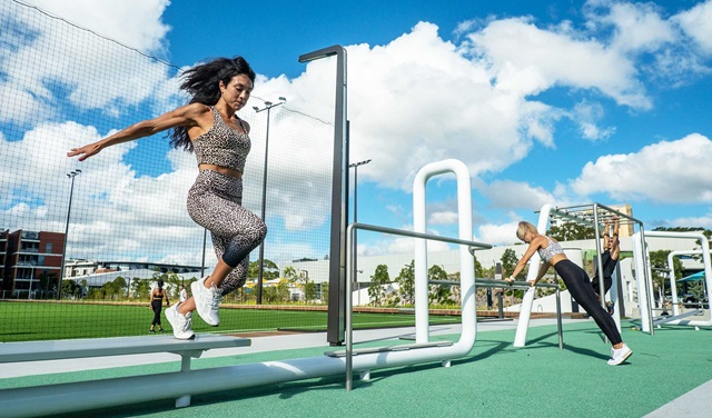 People using the outdoor fitness station