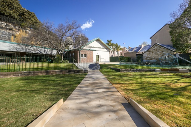 Pathway running throuh Nita McCrae Park up to community centre building.