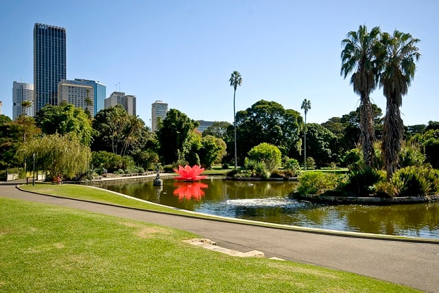 Lake with a garden island and cityscape in the background.