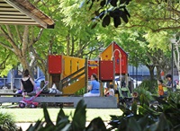The playground area shaded by trees inTote Park.