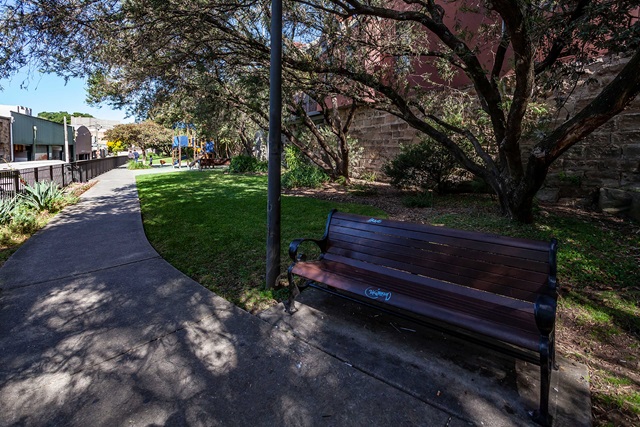 A bench next to a lamp post.