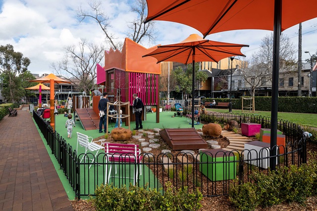 A playground with people and a group of people.