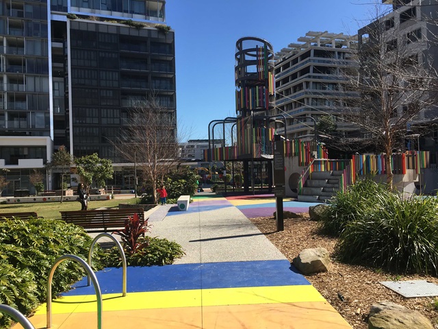 A park with a playground and colorful walkway.