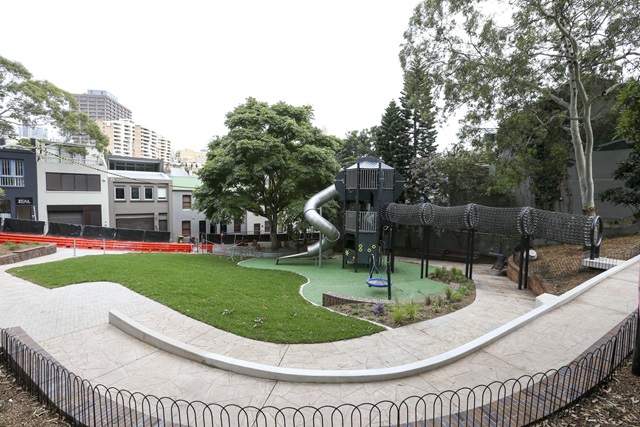 A fence surrounds the play equipment. There's also a structure path near the fence.