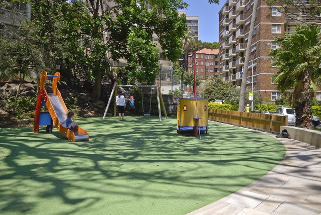 Toddler on swing and slide and Beare Park Playground