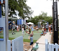 A view from the fence of the playground filled with children playing