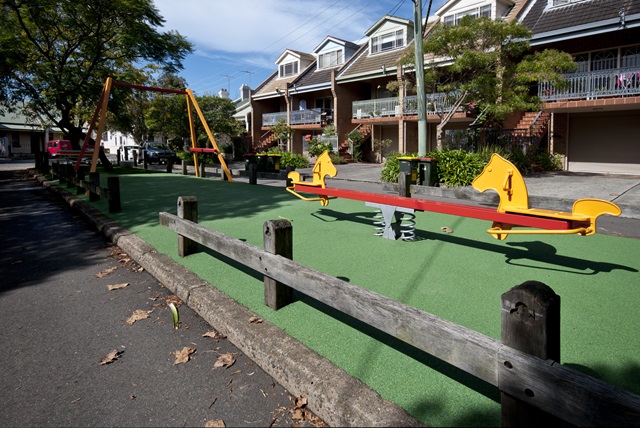 The children's playground features a seesaw
