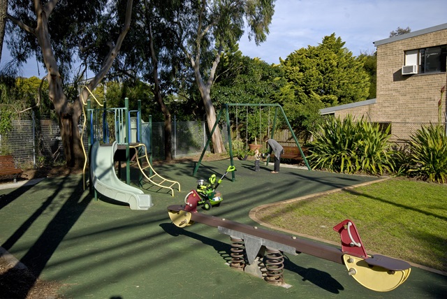Children's play equipment including seesaw and slide