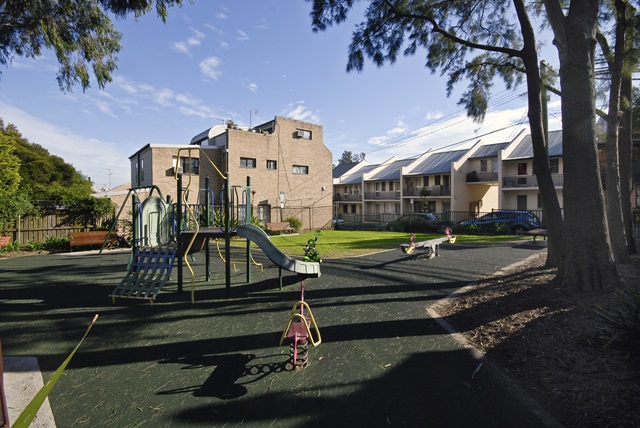 Children's play equipment including climbing structure and slide