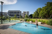 Child playing in water play area with fountain at Mary O'Brien Reserve Playground