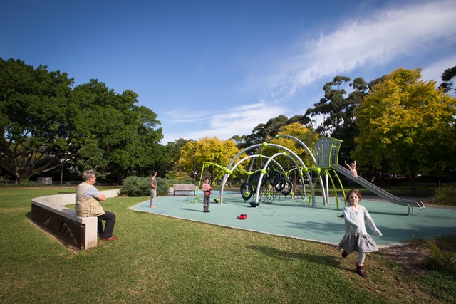 Family playing on slide and climbing equipment at Mary O'Brien Reserve Playground