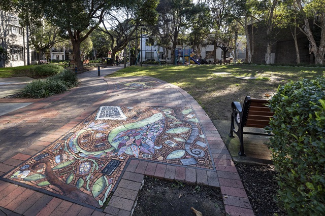 View of chalk drawings on footpath at Peace Park Playground