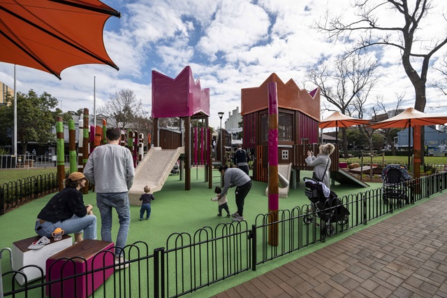 Families in the foreground at the colorful Shannon Reserve Playground.