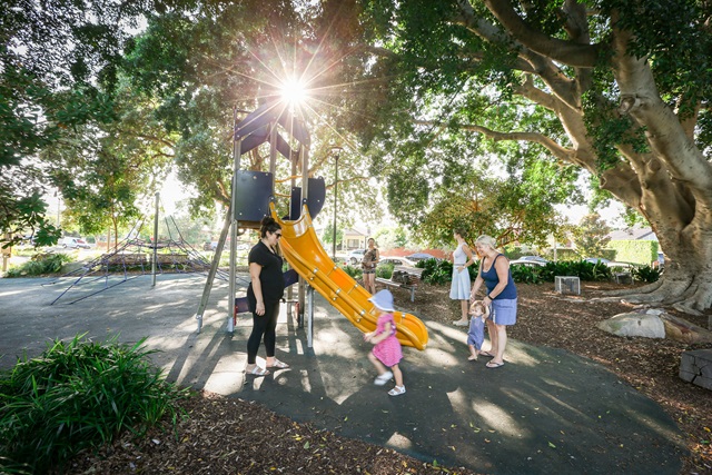 Children playing in playground area in Turruwul Park Playground.