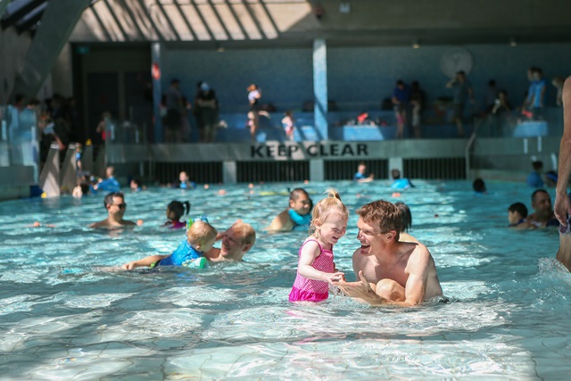 Father and daughter in a learning to swim class