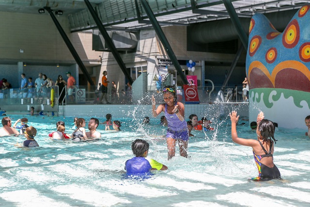 Young children splashing and playing in the children's pool