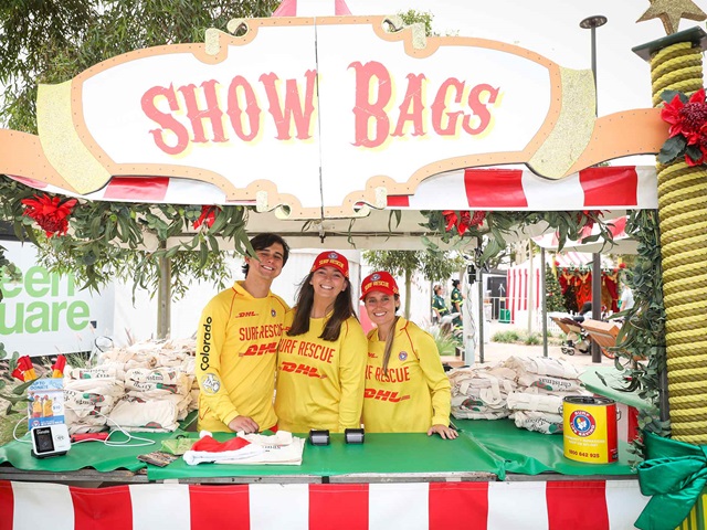 People at a stall selling show bags during a Christmas fair.