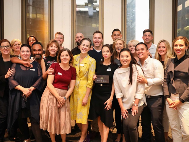 A group of adults posing for a photo.