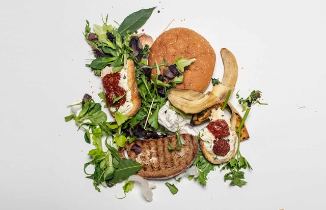Half eaten, wilted bread salad and banana on a plate