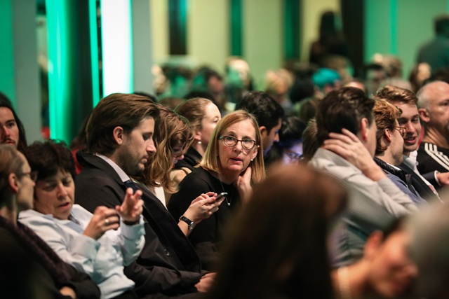 A group of people sitting in a conference.