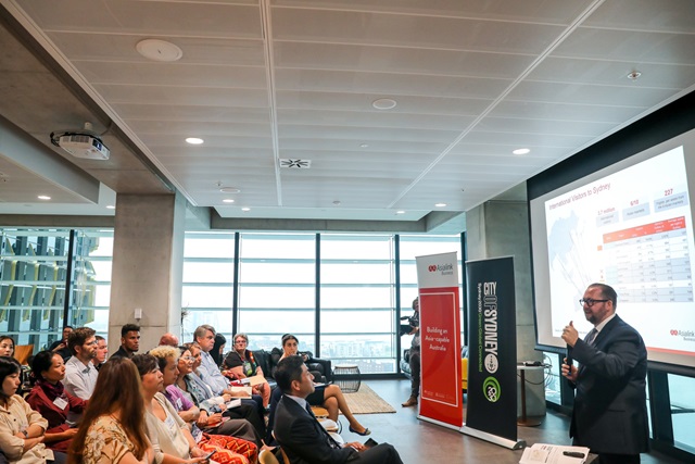 Person giving a talk to a full seminar room