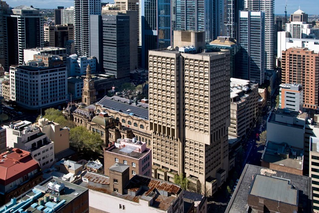 Aerial view of Town Hall House, a 23-storey tall modernist office building with a beige concrete facade.